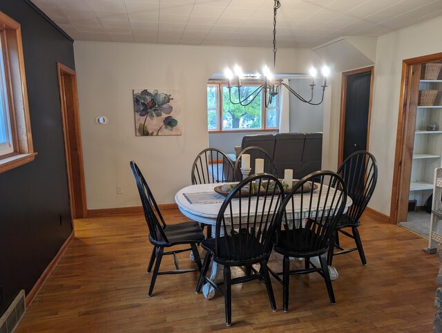 dining area featuring a chandelier and hardwood / wood-style flooring