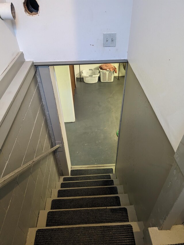 stairs with concrete flooring