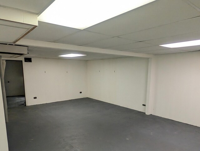 basement with a paneled ceiling