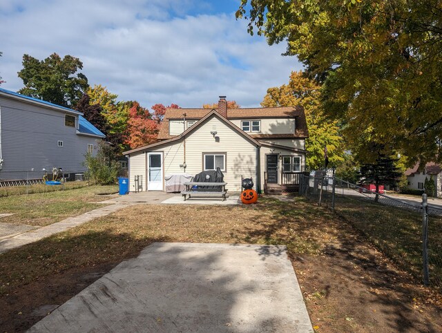 rear view of house featuring a yard and a patio