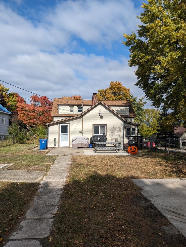 back of house with a lawn