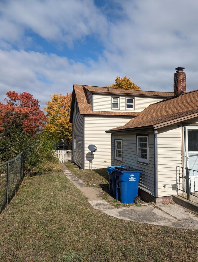 rear view of house featuring a yard