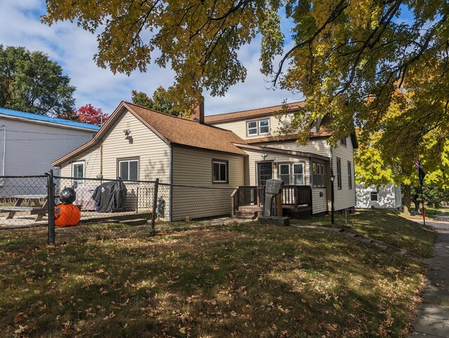 back of property with a lawn