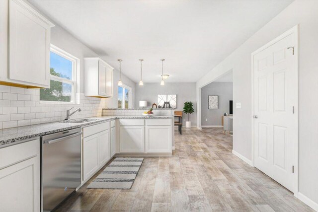 kitchen with dishwasher, pendant lighting, kitchen peninsula, and white cabinets