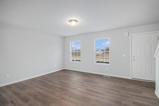 unfurnished room with dark hardwood / wood-style floors