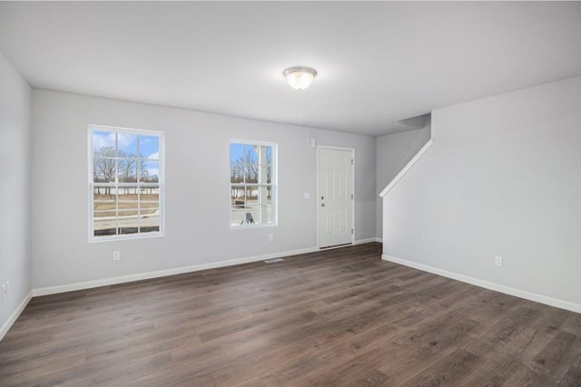 unfurnished room featuring dark hardwood / wood-style floors