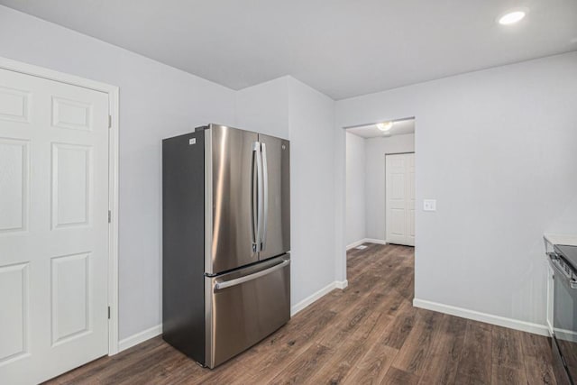 kitchen with dark wood-type flooring and stainless steel refrigerator