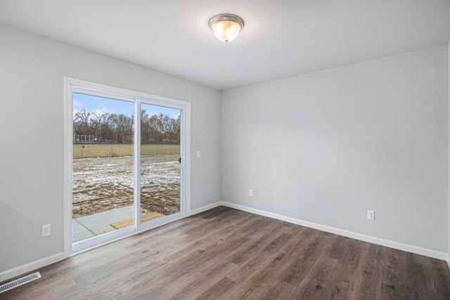 spare room with dark wood-type flooring