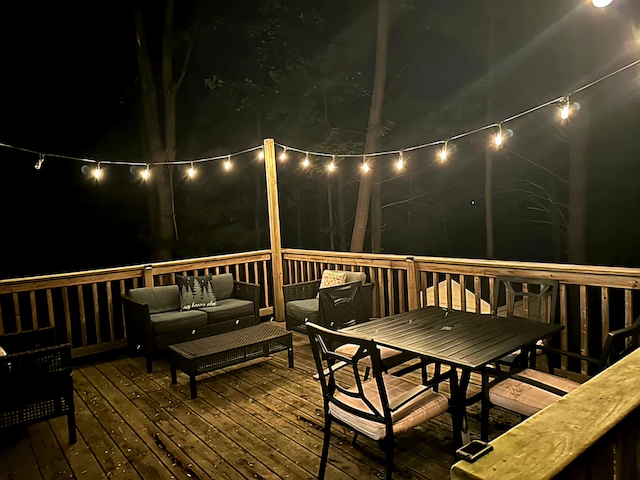 deck at twilight featuring an outdoor hangout area