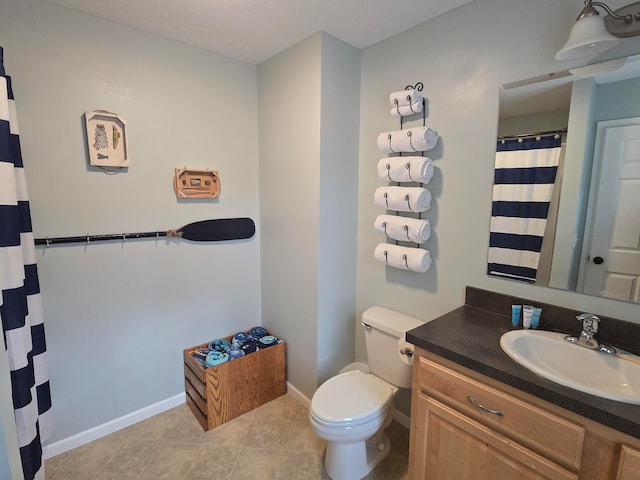 bathroom featuring tile patterned flooring, vanity, and toilet