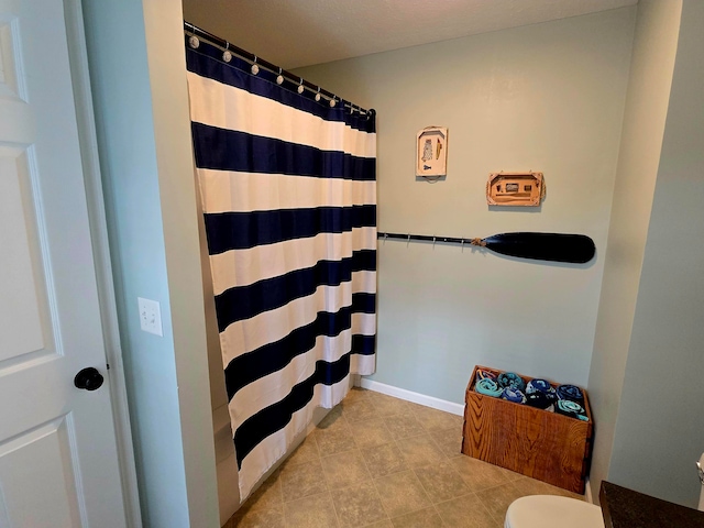 bathroom with toilet and walk in shower