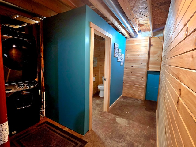 corridor featuring wood walls and concrete flooring