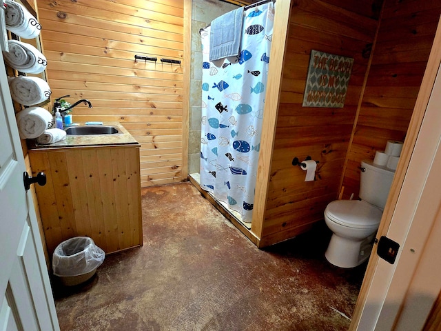 bathroom with toilet, wood walls, sink, and walk in shower