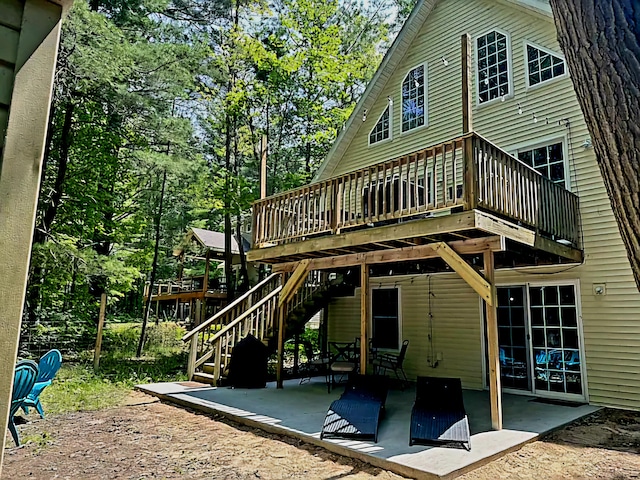 back of house with a patio area and a deck