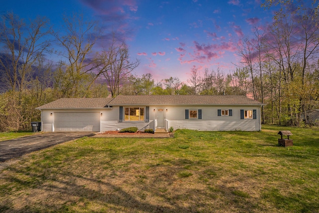 single story home with a yard and a garage