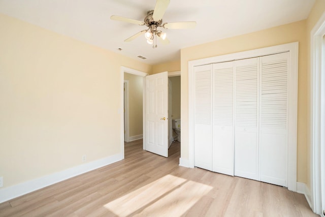 unfurnished bedroom featuring a closet, light hardwood / wood-style flooring, and ceiling fan