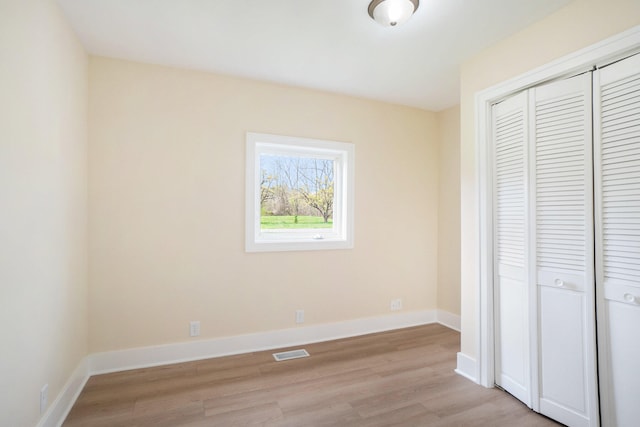 unfurnished bedroom featuring a closet and light hardwood / wood-style floors