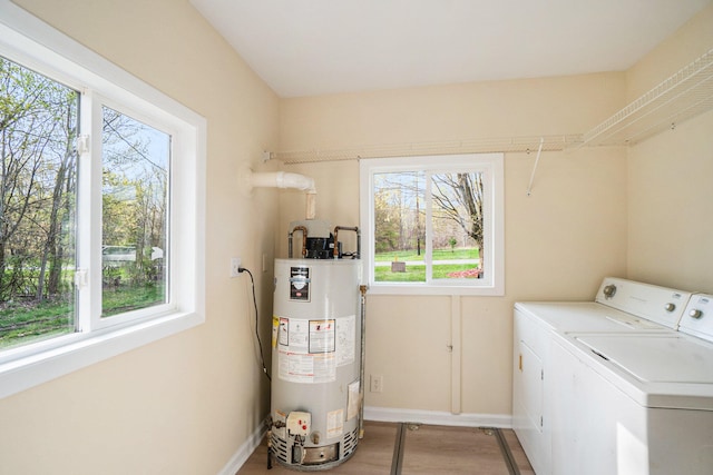 washroom with separate washer and dryer and water heater