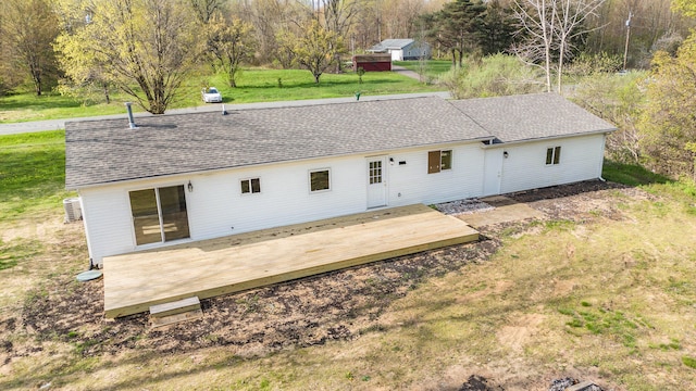 back of house featuring a lawn and a deck