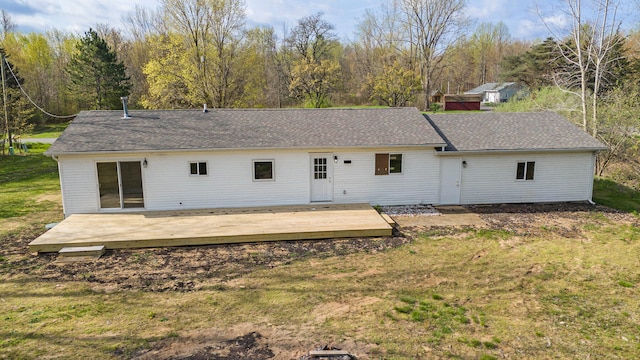 back of property featuring a deck and a yard