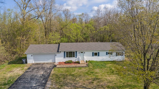 view of front of house with a front yard and a garage