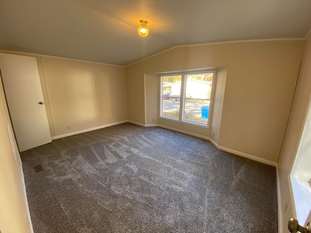 carpeted empty room featuring lofted ceiling and ornamental molding