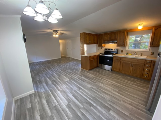 kitchen with stainless steel electric stove, pendant lighting, light wood-type flooring, and sink