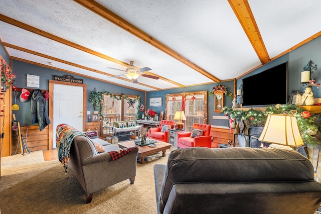 carpeted living room with a textured ceiling, vaulted ceiling with beams, a wealth of natural light, and ceiling fan