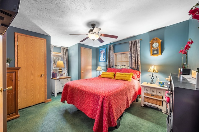 bedroom with a textured ceiling, dark carpet, and ceiling fan