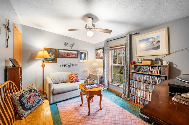 living area featuring lofted ceiling, ceiling fan, a textured ceiling, and hardwood / wood-style flooring