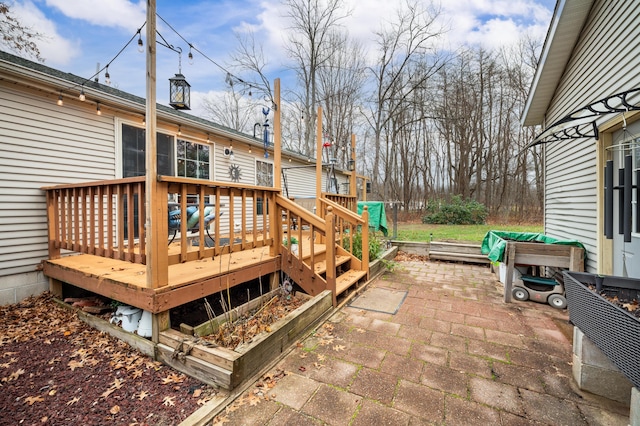 wooden terrace with a patio area