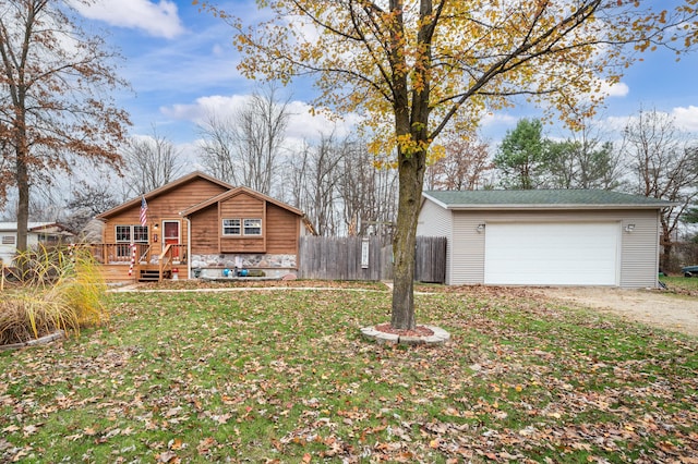 view of front of property featuring a front yard, a garage, and a deck