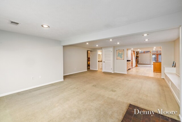 unfurnished living room with light carpet