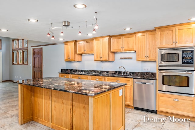 kitchen featuring sink, stainless steel appliances, light tile patterned floors, dark stone countertops, and a kitchen island