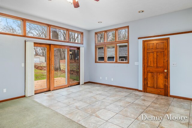 interior space with ceiling fan