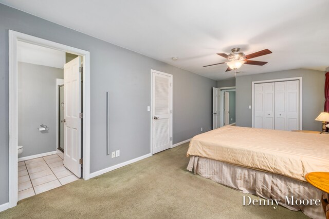 bedroom with ceiling fan, ensuite bathroom, and light carpet