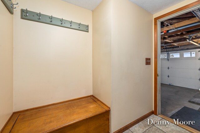 mudroom with a textured ceiling