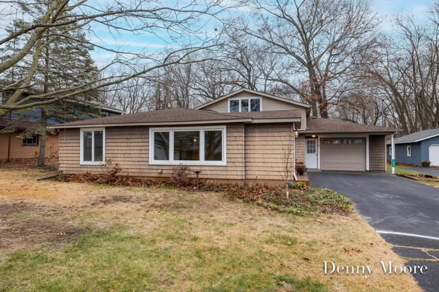 view of front of home with a garage and a front lawn