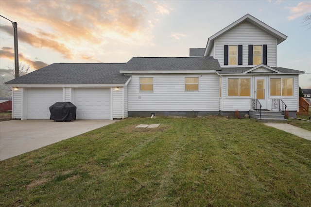 view of front of house with a yard and a garage