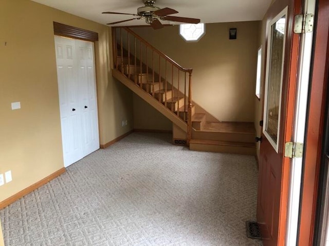 unfurnished living room featuring carpet floors and ceiling fan