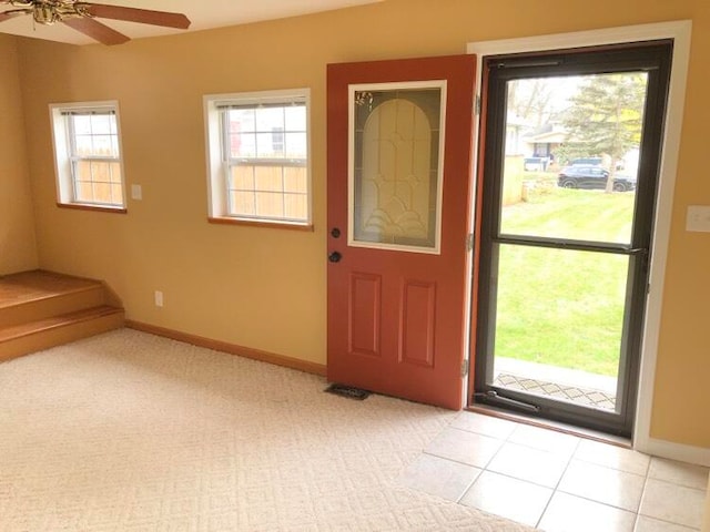 entryway with ceiling fan and light tile patterned flooring