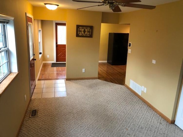 unfurnished room with light hardwood / wood-style flooring and ceiling fan