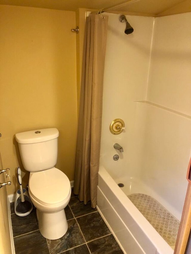 bathroom with shower / bath combo, toilet, and tile patterned floors