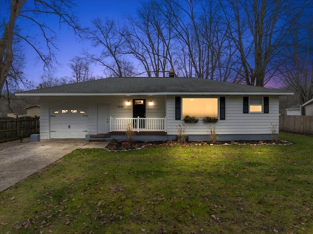 ranch-style house with a yard and a garage