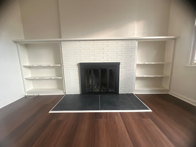 details with a fireplace, wood-type flooring, and built in features