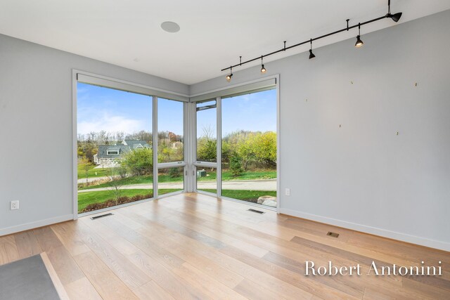 unfurnished room featuring light hardwood / wood-style floors