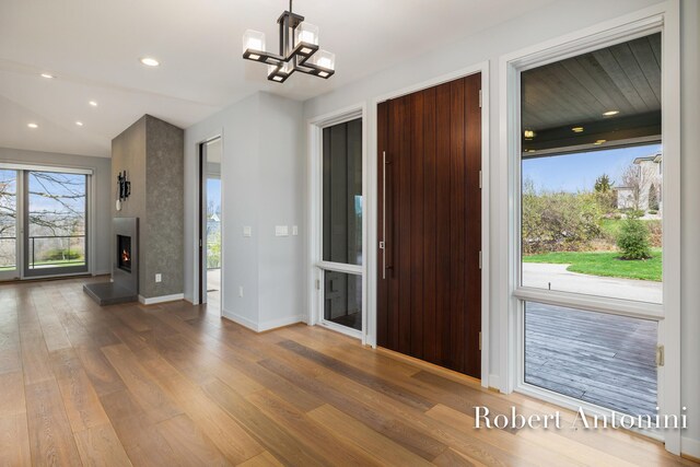 foyer with hardwood / wood-style flooring and a chandelier