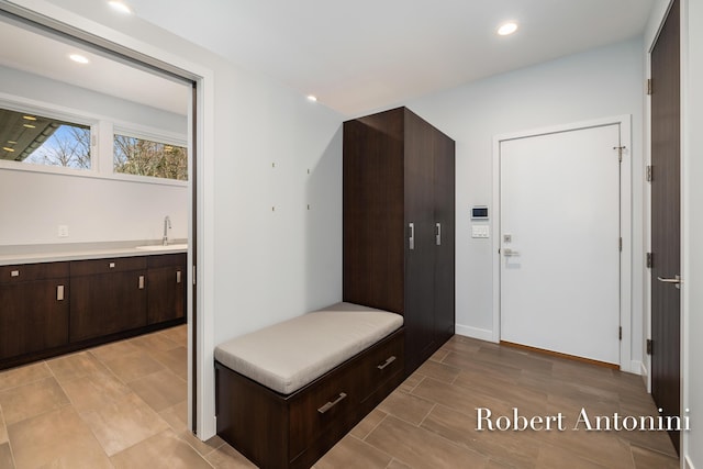 mudroom with light wood-type flooring and sink