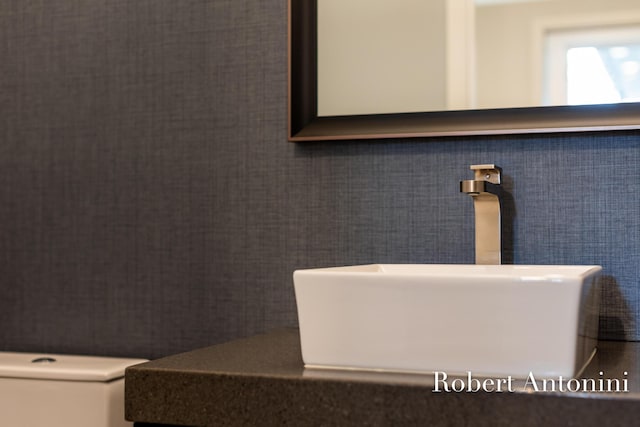 bathroom featuring sink and tile walls