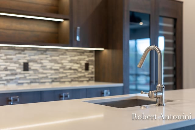 details featuring decorative backsplash and sink